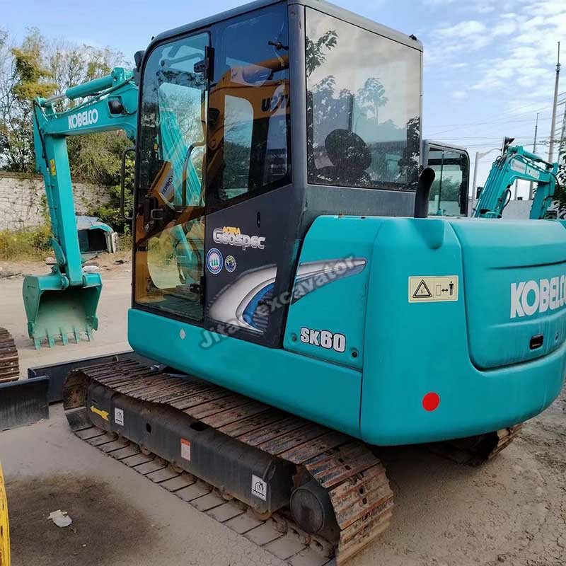 Full side view of a turquoise Kobelco SK60, a premium used compact excavator at Jitao.