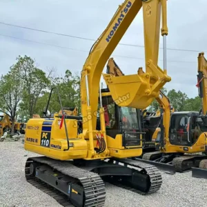 PC110 Boom Reach Komatsu PC110 side view showing boom reach for various used excavator attachments.