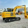 Side view of Komatsu PC130, a top choice for a used mini excavator for sale near me.