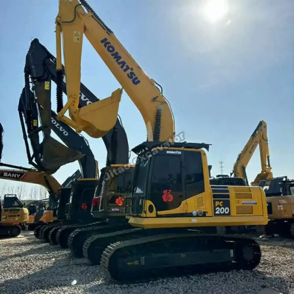 Komatsu PC200 Fleet A row of Komatsu PC200 units, much more powerful than a mini excavator used.