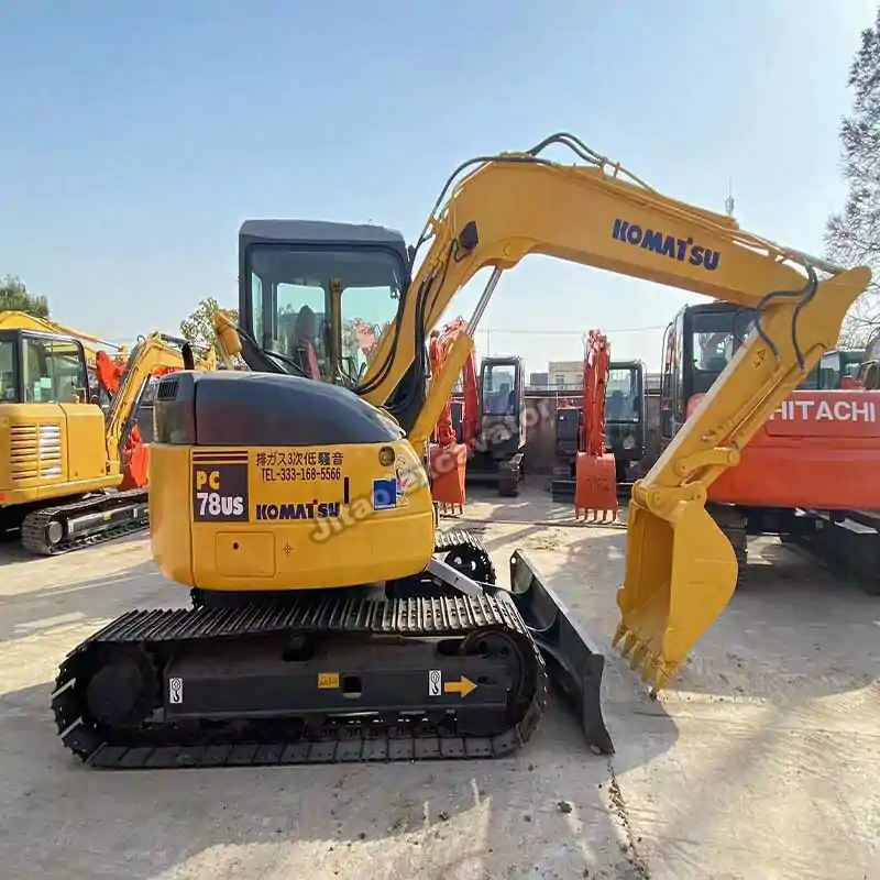 Side view of Komatsu PC78US, a high-quality used small excavator for sale.