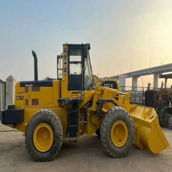 Side view of a Komatsu WA320 used bulldozer for sale near me.
