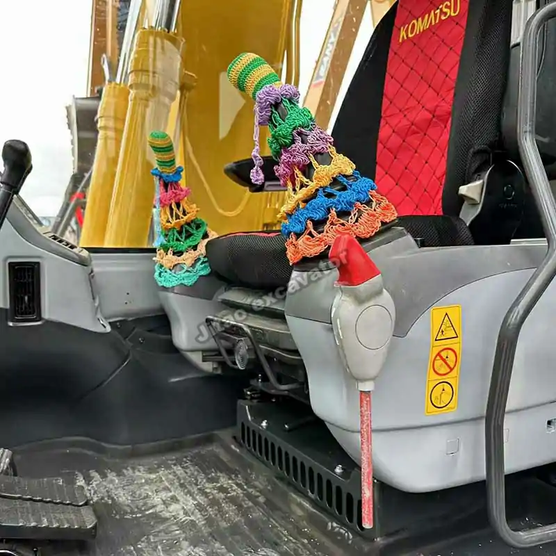 Interior cabin of PC110 with precise controls for used excavator attachments.