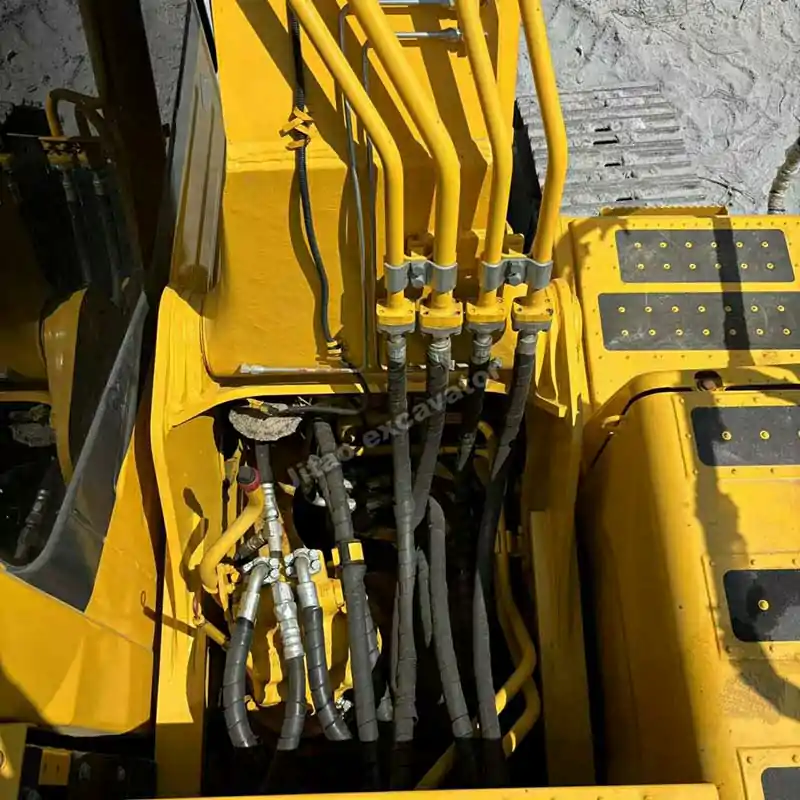 Close-up of Komatsu PC210 hydraulic valves, ready as a high-tier used small excavator alternative.