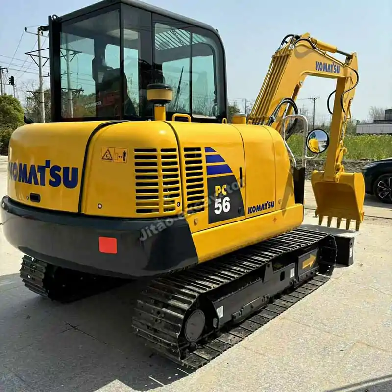 Rear-side view of Komatsu PC56 for customers looking for used mini excavators near me.