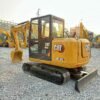 Second-hand CAT 305.5E2 Price Rear-side view showing the dozer blade of a second-hand CAT 305.5E2.