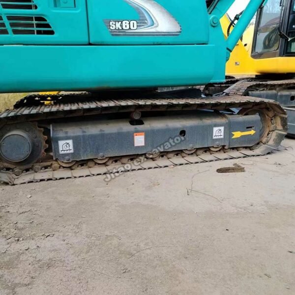 Close-up of the steel tracks and undercarriage of a Kobelco 6-ton machine.