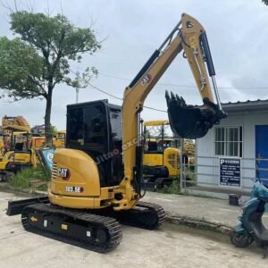Used 3.5 ton mini excavator CAT 303.5E parked at equipment yard.