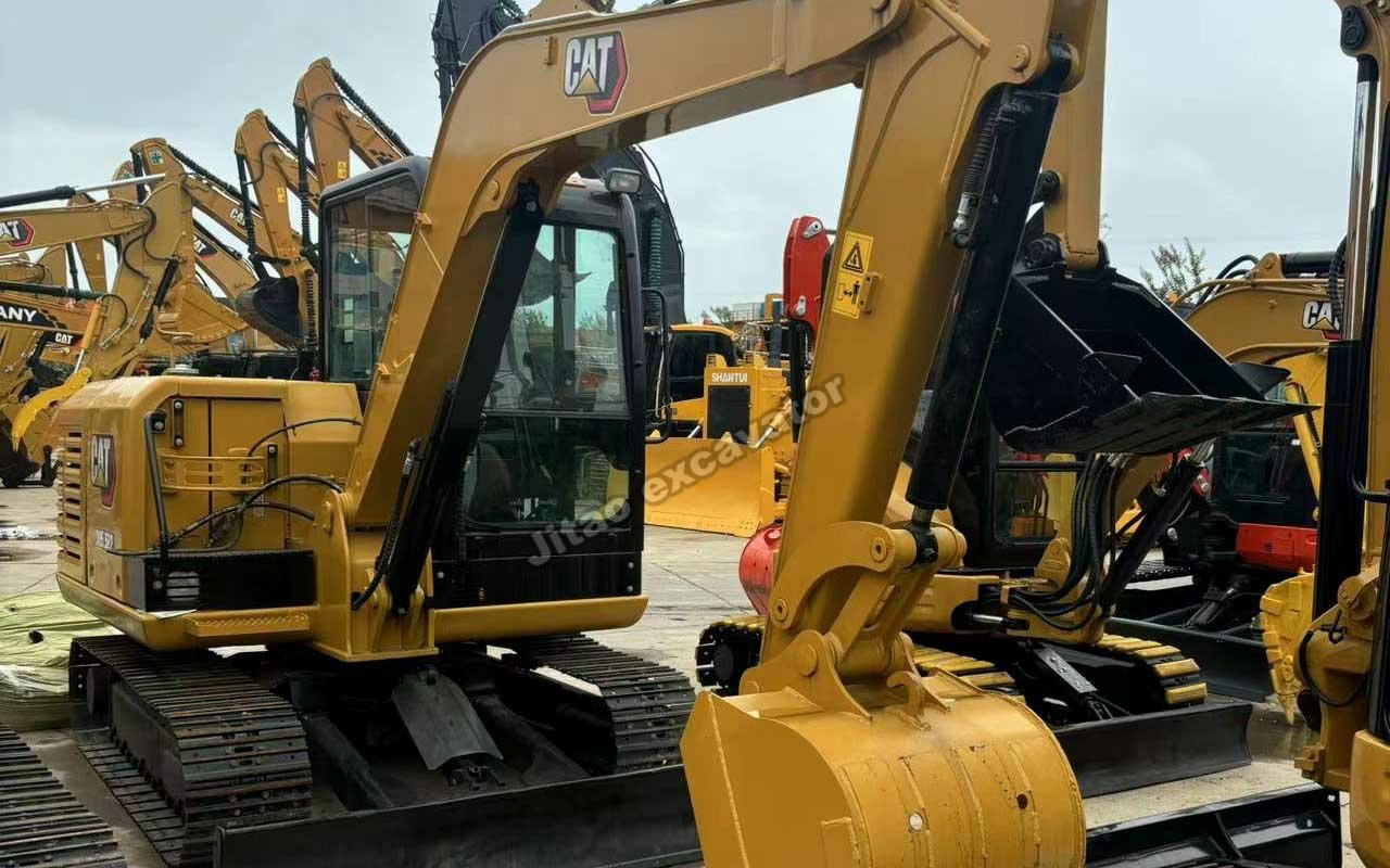 Strong boom and bucket of a used Cat 305.5E2 crawler excavator.