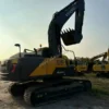 Volvo EC240 featuring a high-capacity used excavator bucket for sale with the unit.
